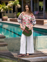 Stylish white blouse with button details, adorned with a striking sleeve print and an elastic neckline for a comfortable fit.