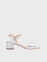 Silver sandal featuring a wide heel, designed for comfort and stability. Ideal for casual or dressy occasions.
