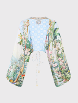 Relaxed fit silk blouse with lace-up closure and crystal accents, featuring a lilac landscape print and blouson sleeves.