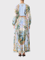 Elegant maxi circle skirt with a voluminous shape, adorned with lilac botanical prints and crystal details, includes side pockets.