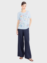 Short-sleeve pullover in sky blue featuring vibrant floral embroidery, crafted from pure viscose for a silky texture.