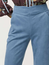 Chic sky-blue faux suede pants featuring a structured waistband, designed for comfort and versatility in everyday wear.