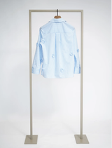 Sky Light Superwhite blouse with a relaxed fit, floral appliqués, and classic shirtwaist design, suitable for casual or elegant wear.
