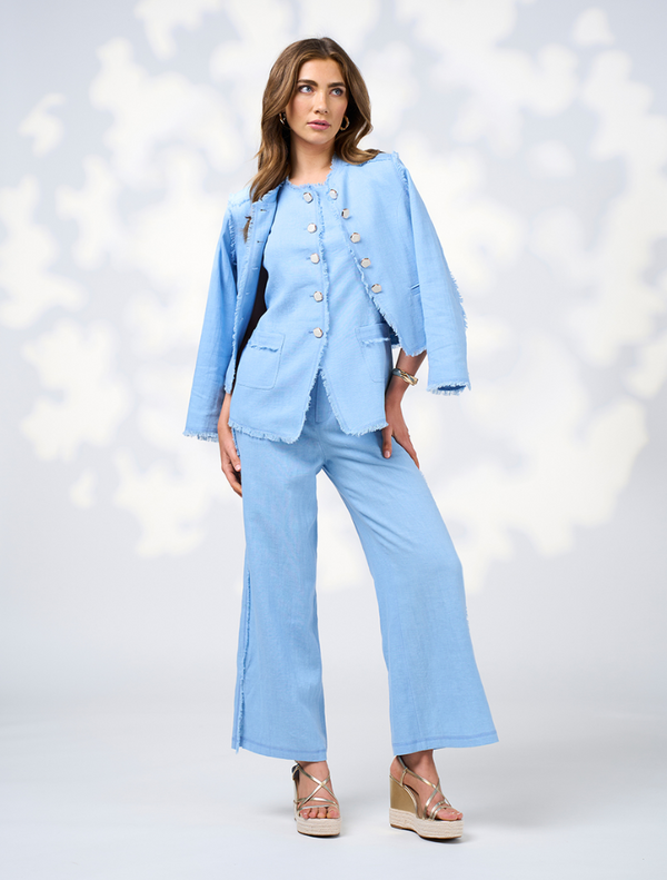 The image features a model in a blue linen suit and sandals, identified as Romee Vest - Sky.