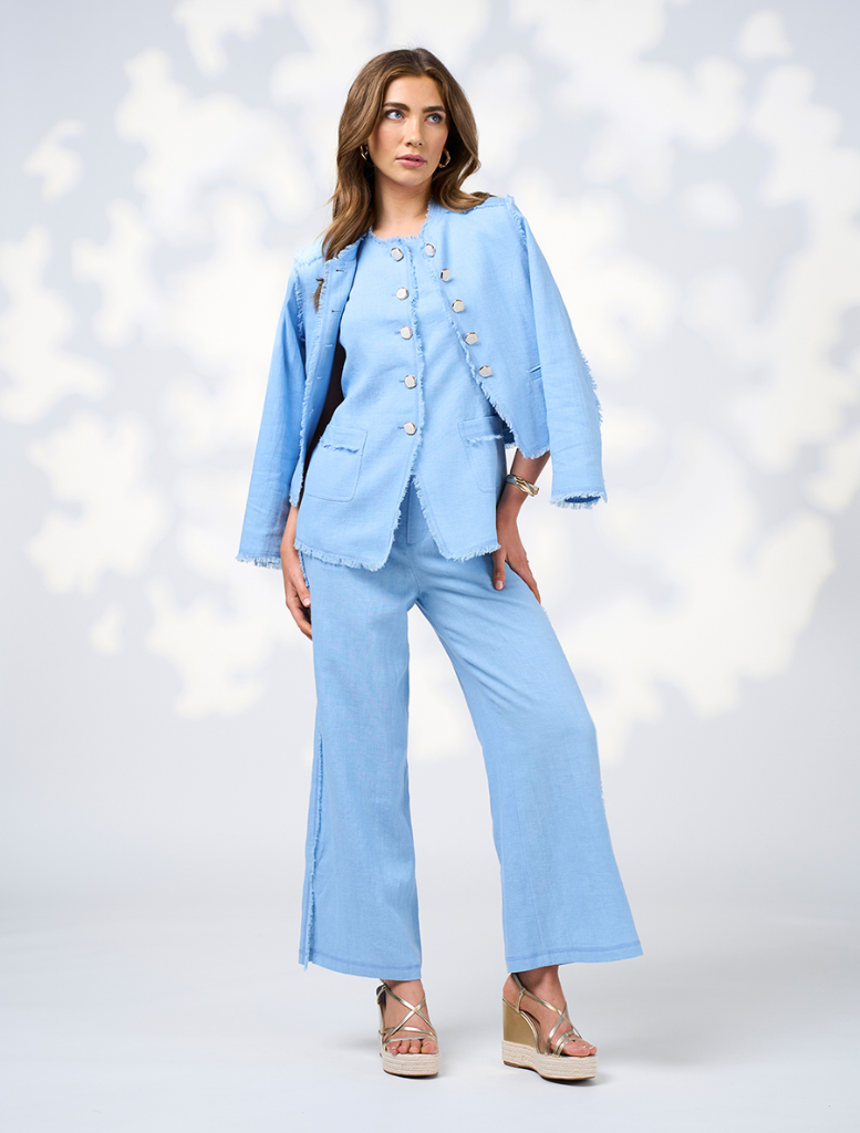 The image features a model in a blue linen suit and sandals, identified as Romee Vest - Sky.