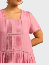 A stylish dress showcasing a bright skyscape print, combining soft blues and pinks for a cheerful summer vibe.