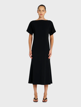 Chic black dress showcasing a slash neck design, short sleeves, and a sleek silhouette for a sophisticated look.
