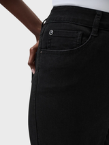 A pair of black slim fit stretch jeans on a neutral surface, emphasizing their contemporary cut and flexibility.