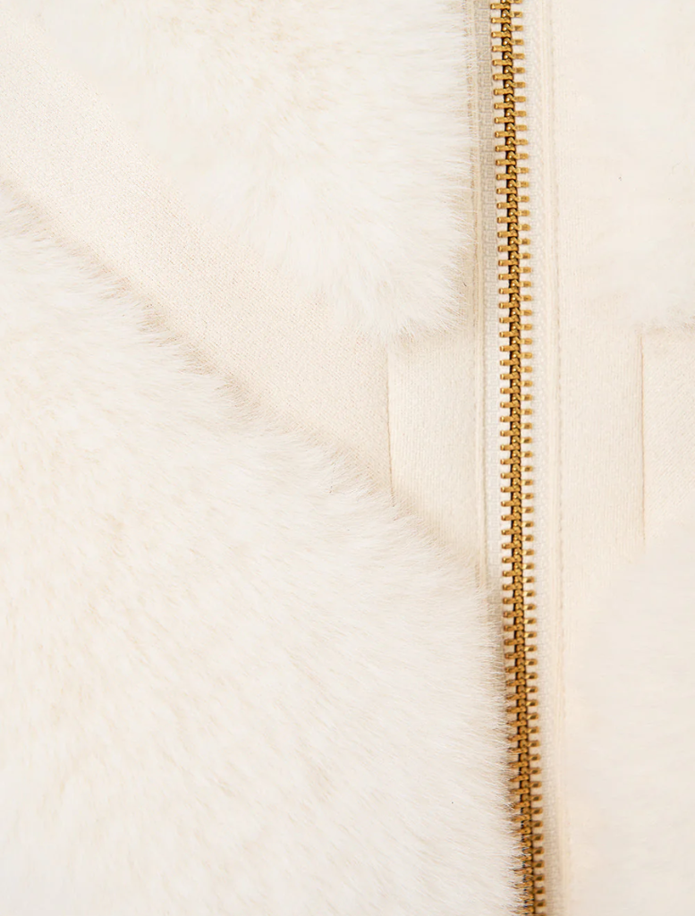 Trendy short sleeve slouch jacket in faux fur, adorned with a tiled pattern, ideal for adding warmth and style.