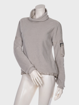 Cozy smoke-colored pullover sweater with a fluffy texture, hanging on a hanger in a well-lit setting.