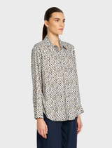 A soft shirt with a pendant detail, emphasizing a casual yet sophisticated look suitable for various occasions.