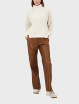 Cozy almond chenille sweater laid flat, emphasizing its warm texture and stylish appearance.