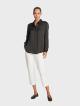 Soft mink shirt displayed on a hanger, showcasing its smooth texture and neutral color.