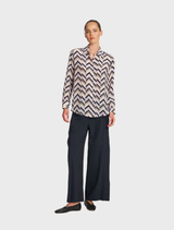 Soft shirt with pleats, featuring a relaxed fit and elegant design, suitable for casual or formal occasions.