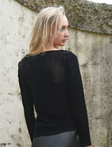 Black Soft Spell Top designed for comfort, showcasing a simple yet stylish silhouette for everyday wear.