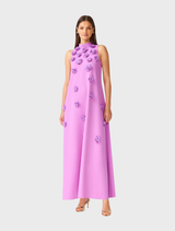 Chic purple maxi dress with a sculptural halter neck, floral embellishments, and a keyhole back, suitable for formal gatherings.
