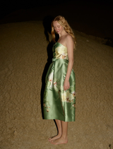 The Sophia Gown, adorned with a Meadow Phalaenopsis pattern, offers a sophisticated look with its elegant draping.