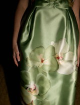 Sophia Gown in a Meadow Phalaenopsis style, highlighting a beautiful floral design and a flowing, elegant shape.