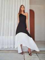 A stylish black and white dress, designed from a single piece of fabric, highlighting its minimalist construction.
