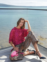 Raspberry t-shirt with light-catching sequins, lace trim, and side vents, offering comfort and a striking appearance.