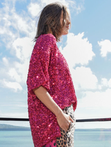 Raspberry t-shirt with sequins, lace trim, and side vents for comfort and style, designed to make a bold statement.