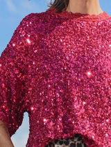 Shimmering raspberry t-shirt adorned with sequins, lace details, and side vents for ease and a fashionable statement.