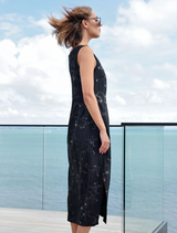 Elegant black dress with sequin embellishments, jersey edging, and side splits for a modern, relaxed fit.