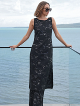 Black dress with embroidered sequins, jersey edging, and side splits, designed for a chic and comfortable look.