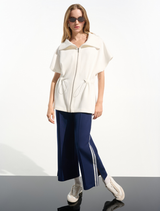 Sporty hip-length jacket in off-white, featuring a modern design suitable for casual and athletic wear.