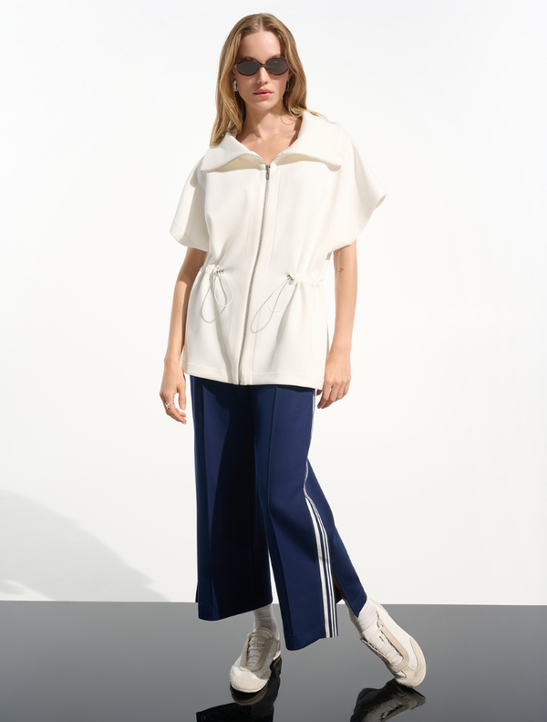 Sporty hip-length jacket in off-white, featuring a modern design suitable for casual and athletic wear.