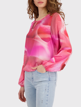 Stylish Monari blouse in pink with an all-over floral print, featuring long sleeves and elasticized cuffs and hem.
