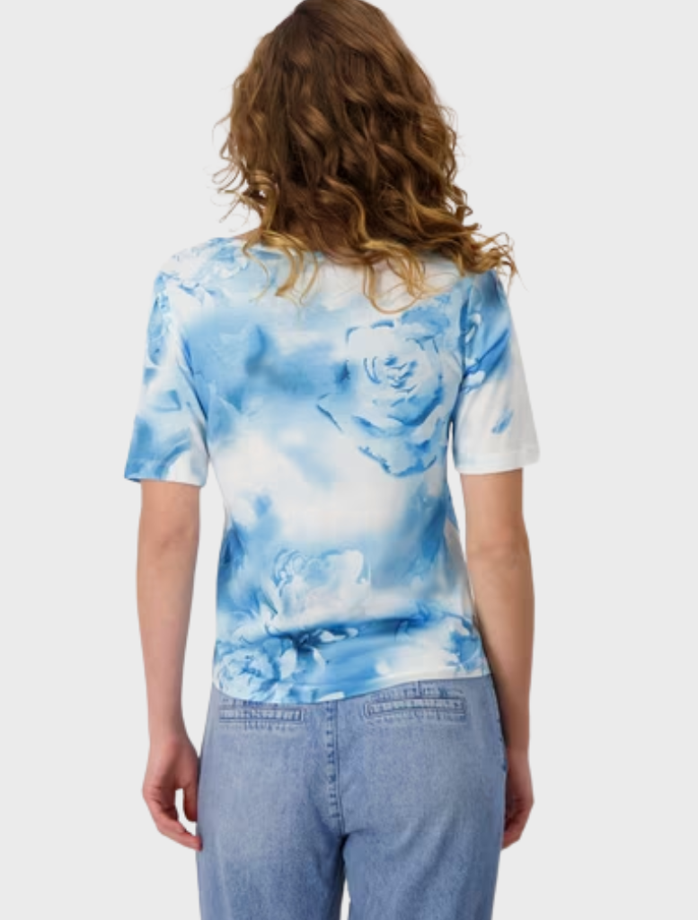 A model wears a stylish blue and white tie-dye shirt, characterized by its eye-catching pattern.