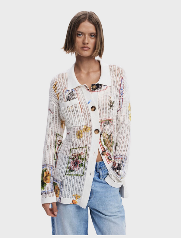 A model showcases a white shirt adorned with a vibrant floral print.