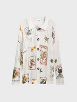 A model displays a white shirt decorated with a bright floral motif.