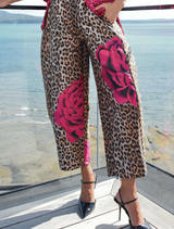 Leopard floral trousers with a barrel-leg silhouette and elasticated back waistband for comfort and modern style.