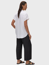 White Mache Stand Shirt presented on a hanger, emphasizing its modern stand collar and button-up style.
