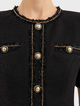 Fashionable black mini dress suitable for stargazing, featuring a modern cut and intricate star embellishments.