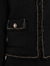 Black Stargazing Jacket shown on a hanger, focusing on its elegant design and texture.
