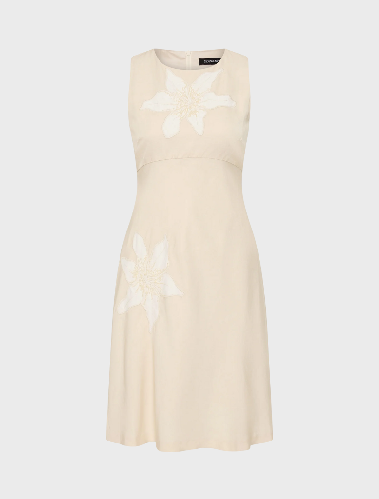 Elegant Nikita short dress in a straw hue, perfect for warm weather events and versatile styling options.