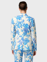 Back view of a woman in a blue and white floral suit, featuring the Leandro Contrast Lace Linen Viscose Stretch Blazer.