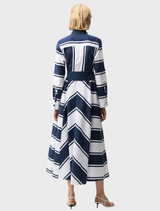 Back view of a woman in a navy and white striped maxi dress, showcasing a casual and stylish summer look.