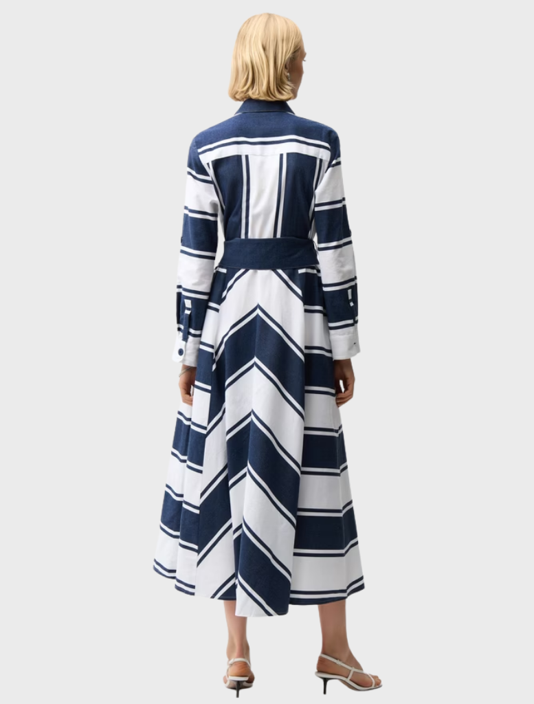 Back view of a woman in a navy and white striped maxi dress, showcasing a casual and stylish summer look.