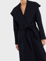Navy Bower Coat showcased on a hanger, featuring a sophisticated design ideal for both casual and formal settings.