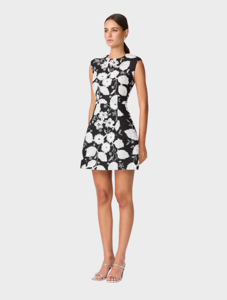 Black and white floral dress designed to resemble a flower, showcasing intricate petal-like patterns and elegant lines.
