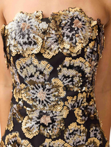 Stunning Celeste gown in black and gold, designed with a flattering shape and luxurious fabric for special occasions.