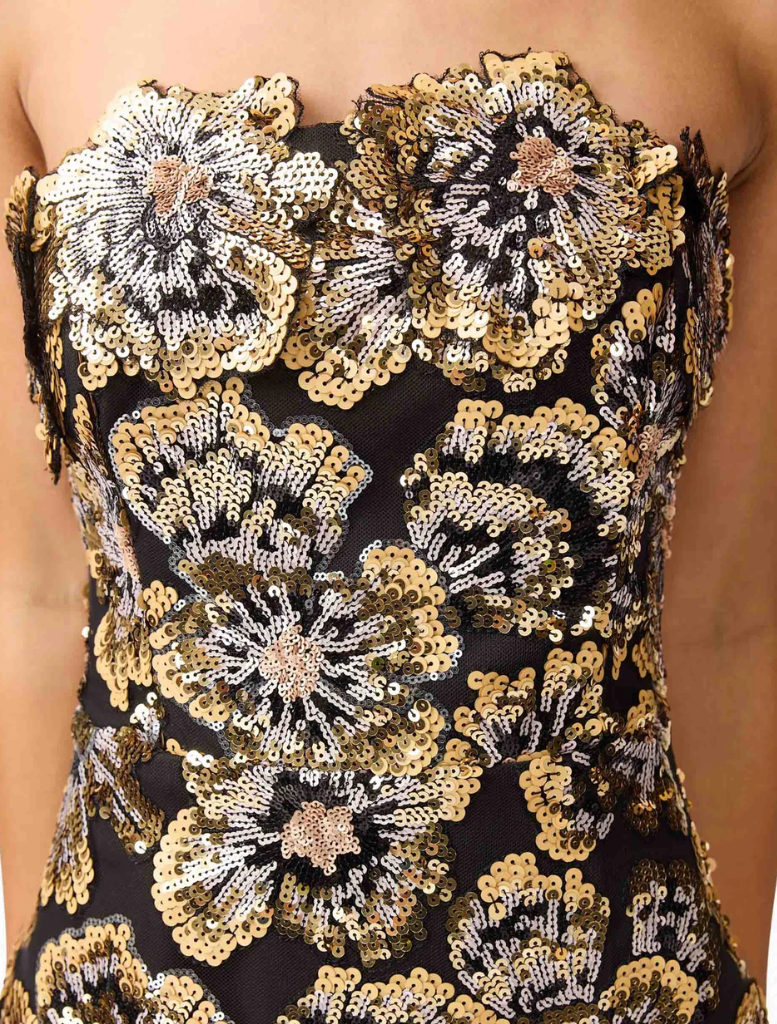 Stunning Celeste gown in black and gold, designed with a flattering shape and luxurious fabric for special occasions.