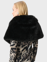 Black cover-up featured on a model, illustrating its fit and flow, perfect for casual or beachwear.