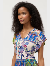 Stylish tiered tea-length dress paired with a floral Armeria scarf, perfect for formal events or casual gatherings.