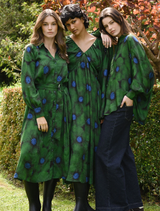 Floral green shirt with the phrase "Living The Dream" artistically printed, perfect for casual wear.