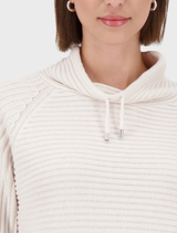 Soft almond Monari rib sweater, featuring a timeless ribbed pattern, perfect for casual and relaxed settings.